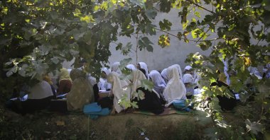 Afghan students attend an open air class at a primary school in Kabul, Afghanistan, Oct. 7, 2020. (AP Photo)