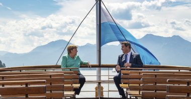 German Chancellor Angela, left, and Markus Soeder, right, Governour of the German state of Bavaria, talk during a boat tour in Priem Am Chiemsee, Germany, July 14, 2020. (AP Photo)