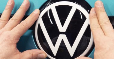 A worker completes an electric car ID.3 body at the assembly line during a press tour at the plant of the German manufacturer Volkswagen AG (VW) in Zwickau, eastern Germany, Feb. 25, 2020. (AP Photo)