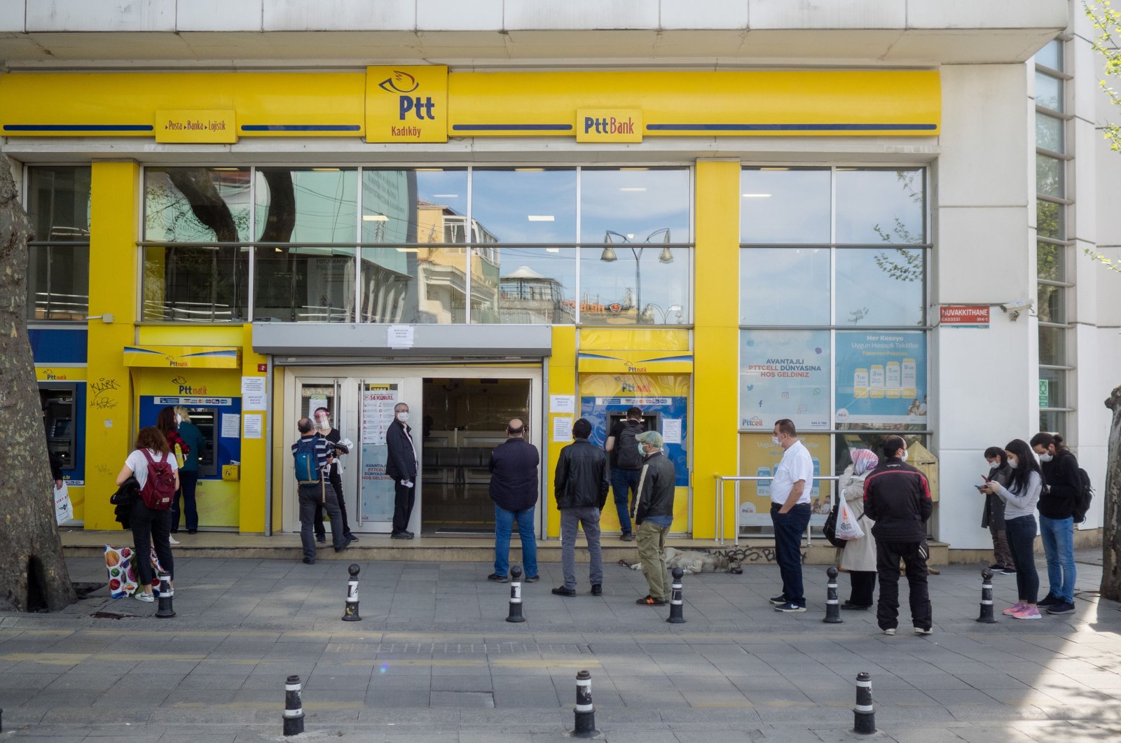 People wait in line at a PTT office, Kadıköy, Istanbul, Turkey, April 30, 2020. (Photo by Shutterstock)