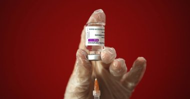 A health worker shows how she prepares a dose of the AstraZeneca vaccine at a vaccination center set up in front of Rome's Termini central station, March 8, 2021. (AP Photo)