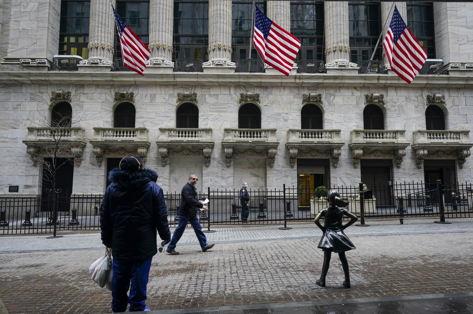 Pedestrians pass the New York Stock Exchange, New York, U.S., Tuesday, Feb. 16, 2021. (AP Photo)