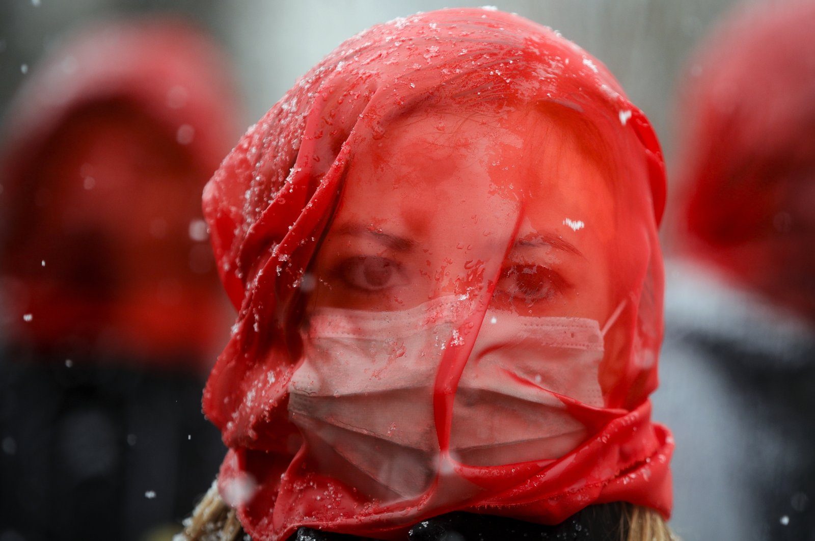 A woman wears a red veil during a flashmob to raise awareness of the increased levels of violence against women since the COVID-19 pandemic started one year ago, in Bucharest, Romania, March 10, 2021. (AP Photo)