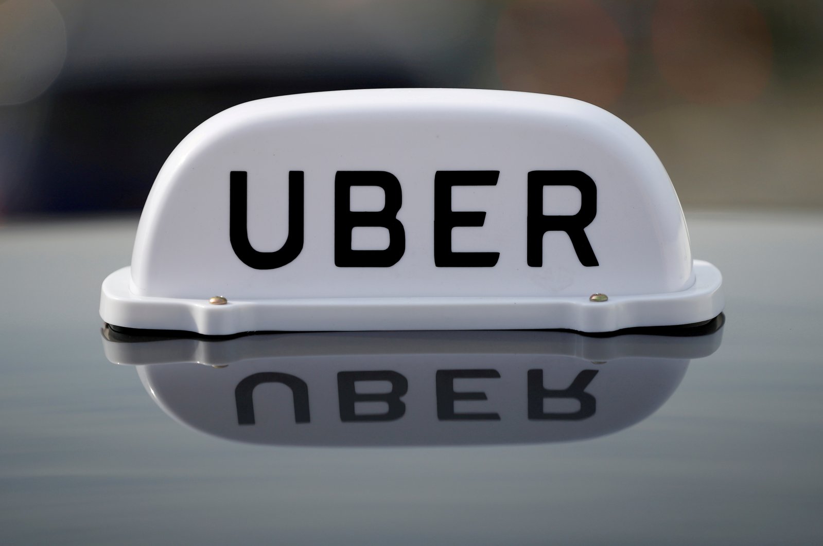 The logo of taxi company Uber is seen on the roof of a private hire taxi in Liverpool, U.K., April 15, 2019. (Reuters Photo)