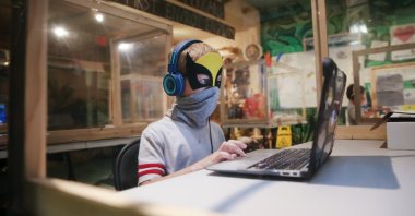 A student takes a livestream class while seated in a socially distanced protective learning pod at an education center in Culver City, California, U.S., Sept. 2, 2020. (Photo by Getty Images)