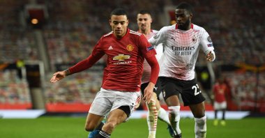 Manchester United striker Mason Greenwood (L) goes past AC Milan defender Fikayo Tomori (R) during a UEFA Europa League round of 16, first leg match at Old Trafford in Manchester, England, March 11, 2021. (AFP Photo)