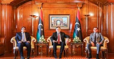 Libya's Prime Minister Abdul Hamid Dbeibeh (R), Libya's internationally recognized former Prime Minister Fayez Sarraj (C), and Mohammed al-Menfi (L), Head of the Presidency Council, pose for a photo ahead of the handover ceremony in Tripoli, Libya March 16, 2021. (AA)