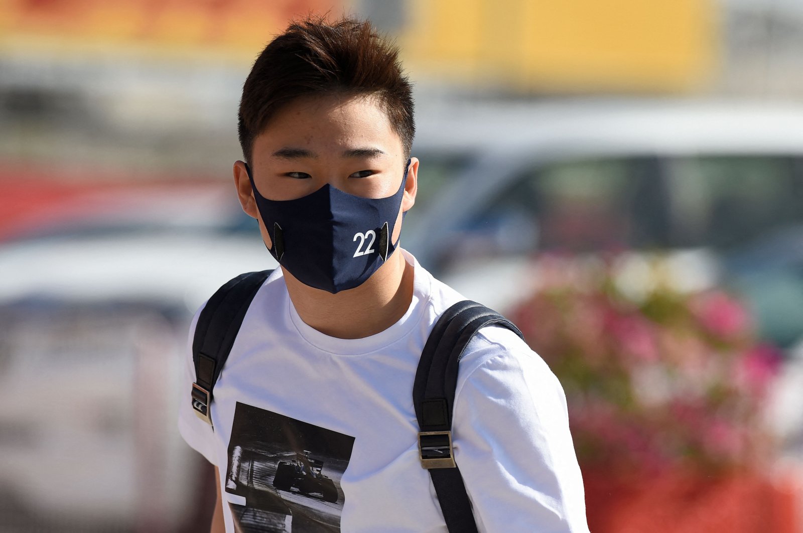 AlphaTauri's Japanese driver Yuki Tsunoda arrives at the circuit before the start of the third day of the Formula One pre-season testing at the Bahrain International Circuit in Sakhir, Bahrain, March 14, 2021. (AFP Photo)
