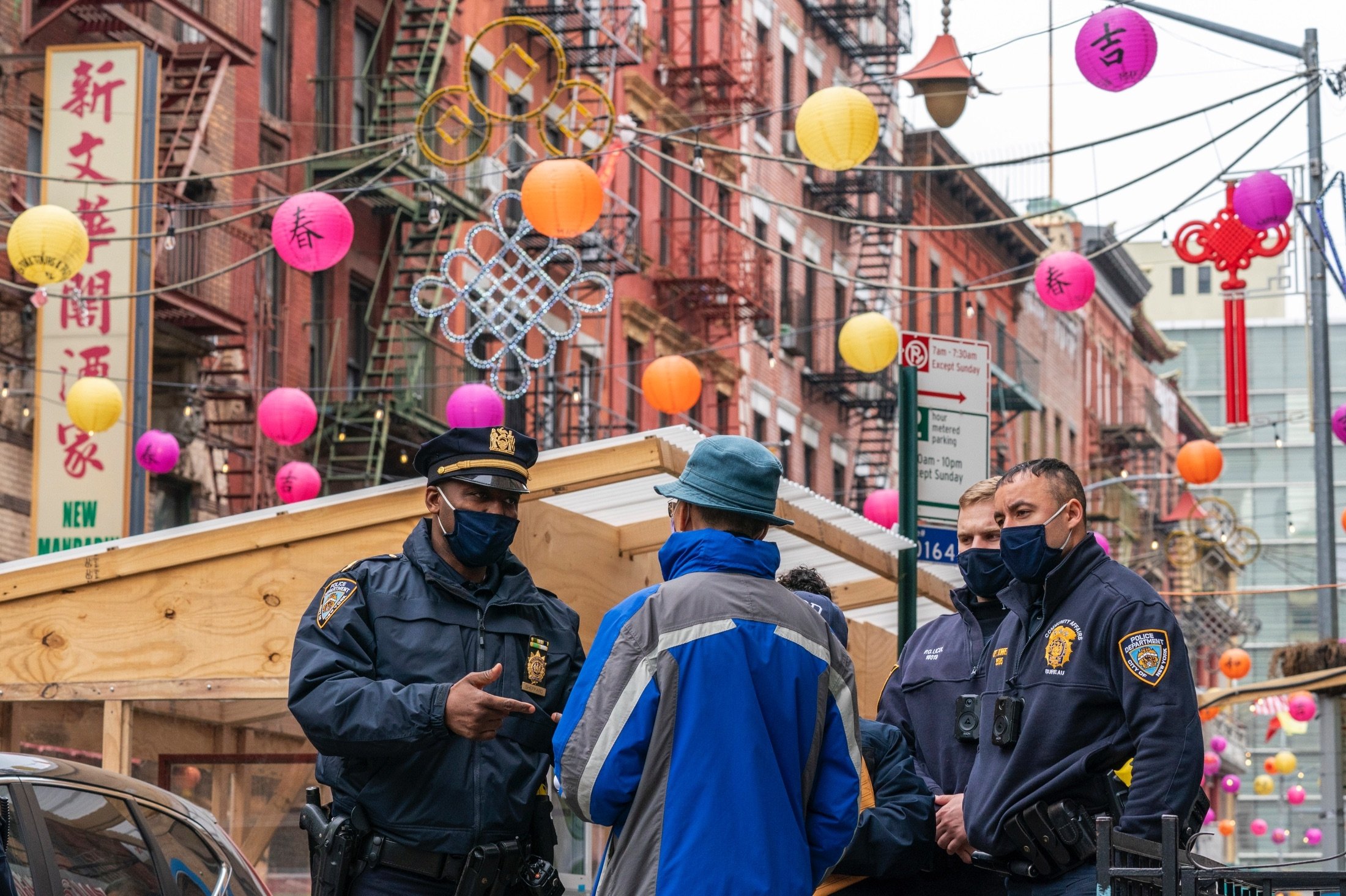 Capt. Tarik Sheppard (L), Commander of the New York Police Department Community Affairs Rapid Response Unit speaks to a resident while on a community outreach patrol in the Chinatown neighborhood of New York, U.S., March 17, 2021. (AP Photo)
