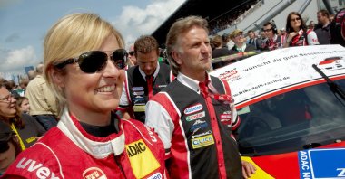 German racing driver Sabine Schmitz (L) of Team Frikadelli Racing standing next to her Porsche racing car during the 24-hour car race on the Nuerburgring race track, Germany, May 19, 2011. (EPA Photo)