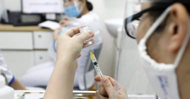 A health worker prepares a shot of COVID-19 vaccine developed by AstraZeneca at a vaccination center of the Vietnam Vaccine Joint Stock Company (VNVC), in Hanoi, Vietnam, March 17, 2021. (EPA Photo)