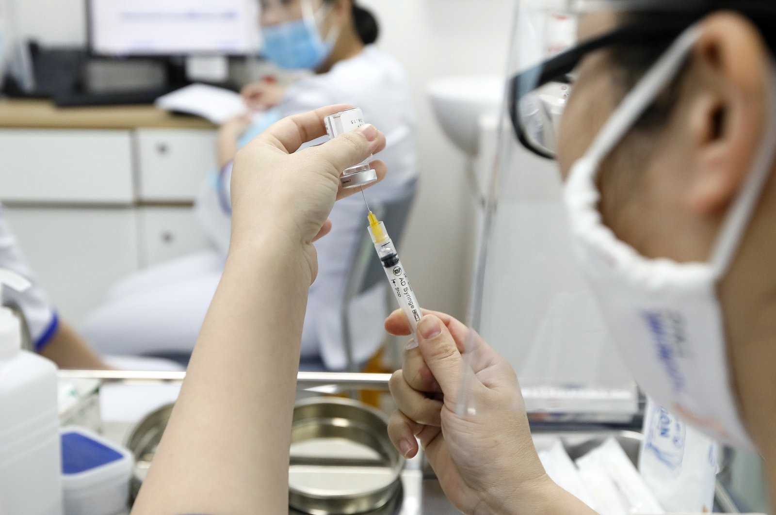 A health worker prepares a shot of COVID-19 vaccine developed by AstraZeneca at a vaccination center of the Vietnam Vaccine Joint Stock Company (VNVC), in Hanoi, Vietnam, March 17, 2021. (EPA Photo)