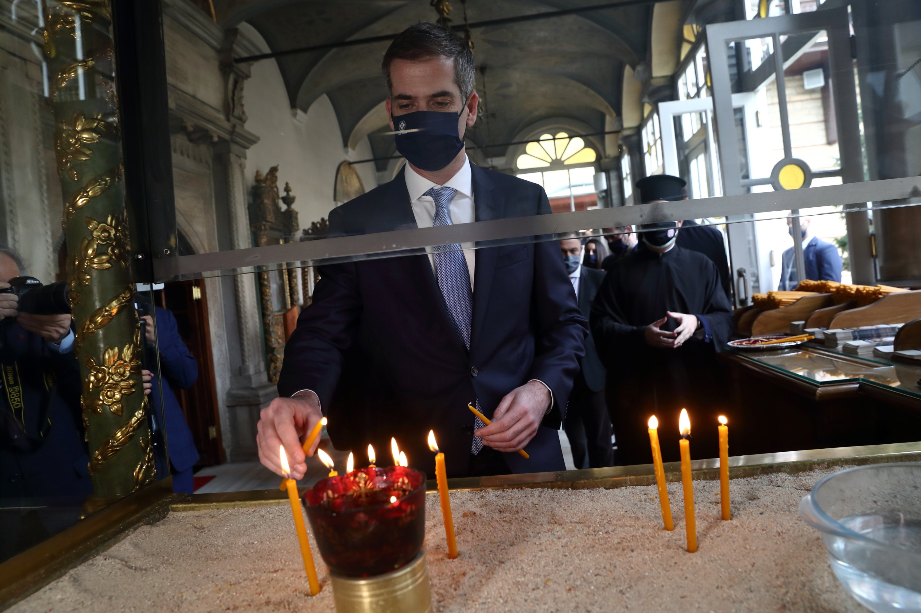 Athens Mayor Kostas Bakoyannis lights candles as he visits the Patriarchal Church of St. George at the Greek Orthodox Patriarchate in Istanbul, Turkey, March 19, 2021. (Reuters Photo)