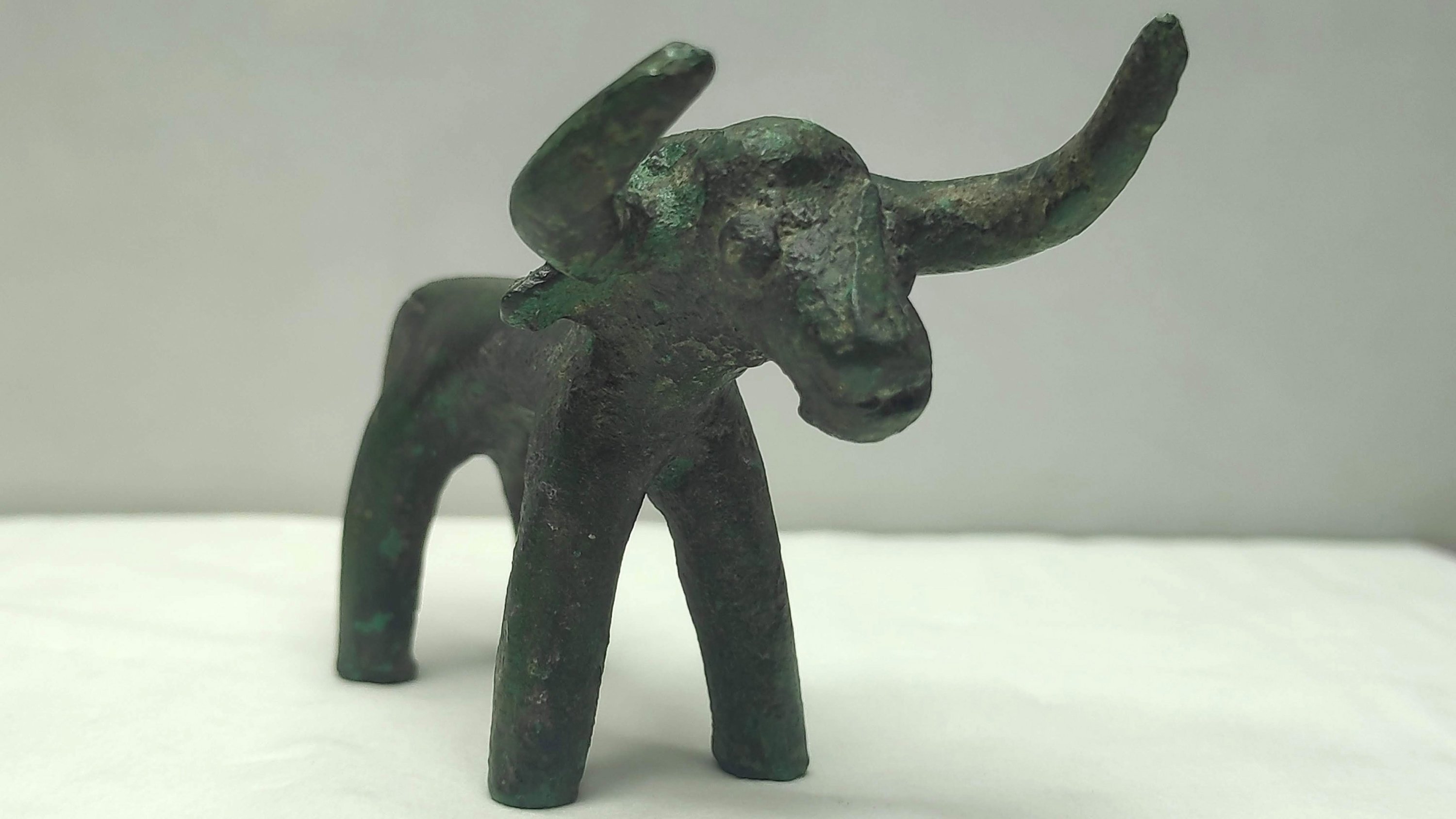 A bronze bull figurine can be seen which was found during an inspection conducted at the archaeological site of Ancient Olympia, Peloponnese, Greece, March 19, 2021. (Greek Culture Ministry via EPA)