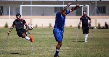 Palestinian players compete during the final of a local football championship for amputees between Al-Jazeera and Al-Abtal, organized by the International Committee of the Red Cross (ICRC), in Gaza City on March 18, 2021. (AFP Photo)