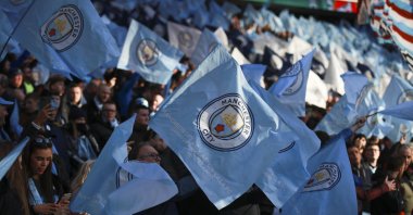 Manchester City fans wave the team's flag prior to the League Cup final against Aston Villa, at Wembley Stadium, London, England, Sunday, March 1, 2020. (AP Photo)