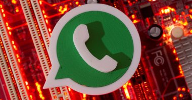 A 3D printed WhatsApp logo is placed on a computer motherboard, January 21, 2021. (Reuters Photo)