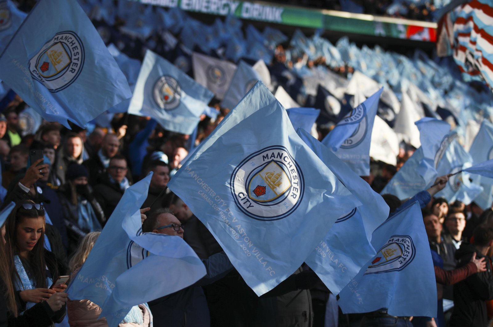 Manchester City fans wave the team's flag prior to the League Cup final against Aston Villa, at Wembley Stadium, London, England, Sunday, March 1, 2020. (AP Photo)
