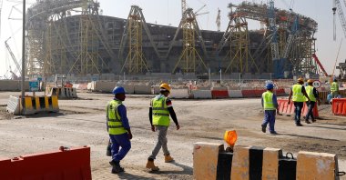 This file photo shows workers walking towards the construction site of the Lusail Stadium which will be build for the upcoming 2022 FIFA World Cup during a stadium tour in Doha, Qatar, Dec.20, 2019. (Reuters Photo)