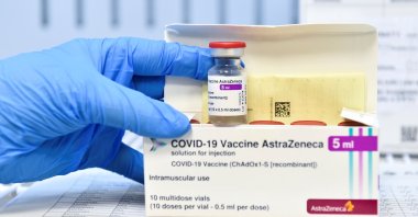 A healthcare worker shows a vial and a box of AstraZeneca's COVID-19 vaccine, in Turin, Italy, March 19, 2021. (Reuters Photo)