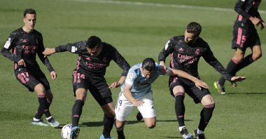 Celta Vigo's Nolito, center, falls between Real Madrid's Casemiro and Nacho during a Spanish La Liga soccer match between Celta and Real Madrid at the Balaidos stadium in Vigo, Spain, Saturday, March 20, 2021. (AP Photo)