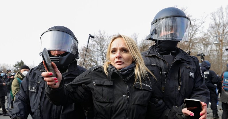 German police detain a protester in downtown Kassel on Saturday, March 20, 2021 (AA Photo)