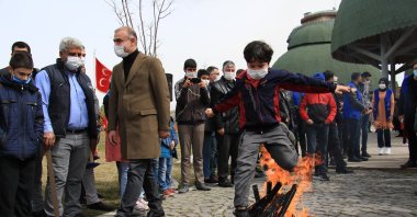 A boy jumps over a bonfire as part of a Nevruz tradition in Elazığ province, eastern Turkey, March 21, 2021. (IHA Photo)