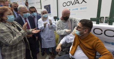 Health Minister Mai Alkaila (L) and Palestinian Prime Minister Mohammad Ishtayeh (2nd L) watch as a man receives a shot of the Pfizer COVID-19 vaccine during a campaign to vaccinate frontline workers, those over 75, cancer patients and medical personnel, at the health ministry in the West Bank city of Ramallah, March 21, 2021. (AP Photo)