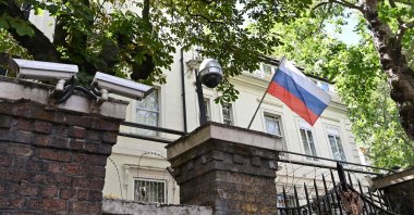 A Russian flag flies by surveillance cameras at the entrance to the Russian consulate in London, July 21, 2020. (AFP Photo)
