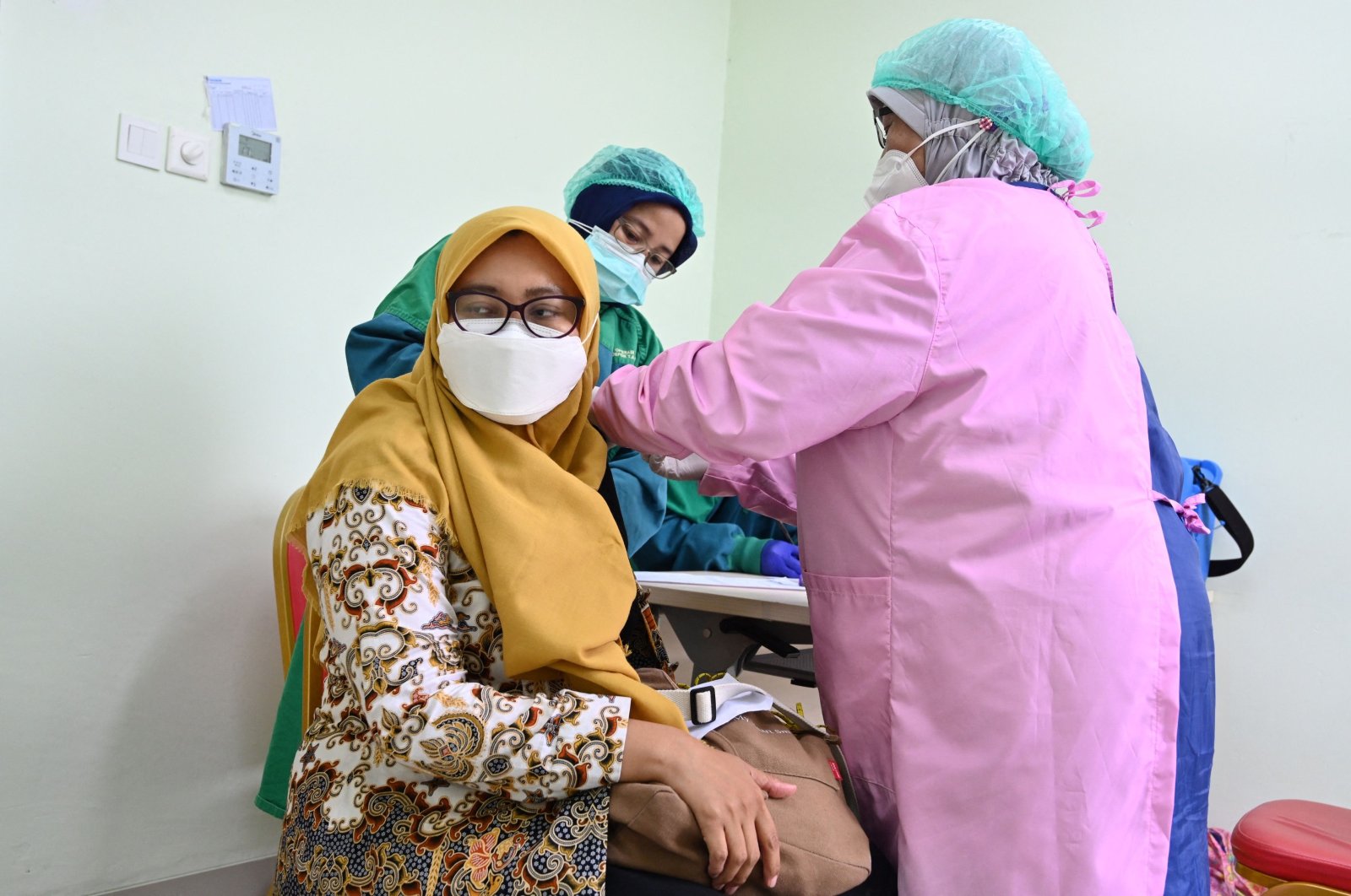 A woman receives a COVID-19 vaccine at the Depok regional hospital in Depok, West Java on March 18, 2021. (AFP Photo)