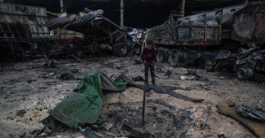 A Syrian child inspects the damage in the aftermath of an airstrike that was allegedly carried out by Russian warplanes on a truck depot near Bab al-Hawa border crossing on the Syrian-Turkish border, Idlib, Syria, March 22, 2021. (Getty Images)