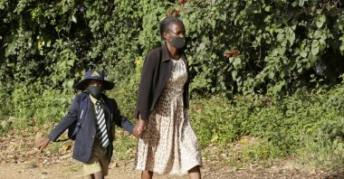 A child wears a face mask to curb the spread of COVID-19 on his way to school following the reopening of schools in Harare, Zimbabwe, March 22, 2021. (AP Photo)