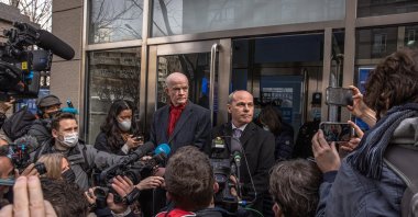 Jim Nickel (C-R), deputy head of the Canadian embassy in Beijing and William Klein (C-L), acting deputy chief of the U.S. Embassy in Beijing, speak to the media at the entrance to the Intermediate People's Court in Beijing, China, 22 March 2021. (EPA Photo)