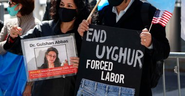Protestors hold signs as they gather during a rally for Uyghur Freedom in New York City on March 22, 2021. (AFP Photo)