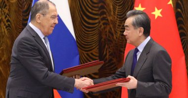 Russian Foreign Minister Sergei Lavrov (L) and Chinese Foreign Minister Wang Yi exchange documents during a signing ceremony following their talks in Guilin, China, March 23, 2021. (Russian Foreign Ministry via AFP)