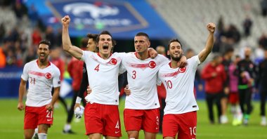 Turkey's Çağlar Söyüncü (L), Merih Demiral (C) and Hakan Çalhanoğlu celebrate after a match against France, at the Stade de France, Paris, France, Sept. 14, 2019. (Sabah Photo)
