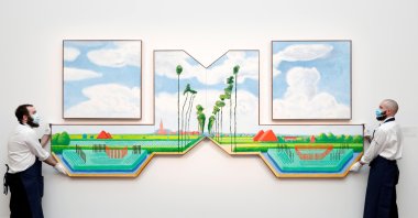 Sotheby's workers pose with "Tall Dutch Trees After Hobbema" by David Hockney, London, the U.K, March 22, 2021. (REUTERS Photo)