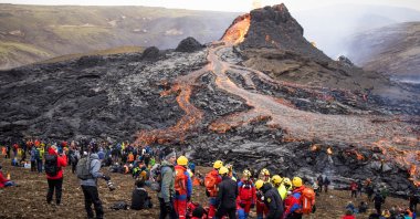 People gather at the volcanic site on the Reykjanes Peninsula following Friday's eruption in Iceland, March 21, 2021. (Reuters Photo)
