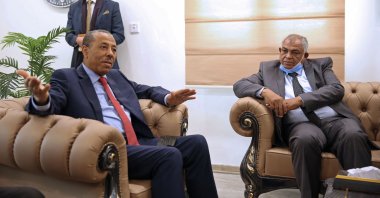 Libya's Deputy Prime Minister in the national unity government, Hussein Attiya al-Gotrani (R), listens to Abdallah al-Thani (L), the former head of the pro-Haftar eastern administration during a handover ceremony in Benghazi, Libya, March 23, 2021. (AFP Photo)