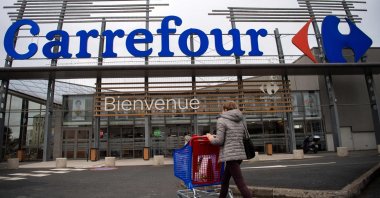 A woman enters a French retail giant Carrefour supermarket in Saint-Herblain, outside Nantes, France, Jan. 13, 2021. (AFP Photo)