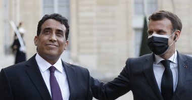 French President Emmanuel Macron (R) and Head of Libya's Presidential Council Mohamed Menfi (L) hold a joint statement after a meeting at Elysee Palace, Paris, France, March 23, 2021.  (EPA Photo)