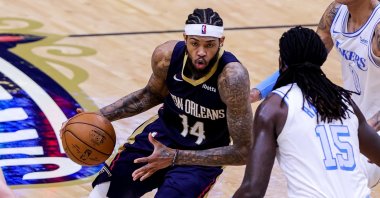 New Orleans Pelicans forward Brandon Ingram (L) dribbles against Los Angeles Lakers center Montrezl Harrell (R) during an NBA game at Smoothie King Center, New Orleans, Louisiana, U.S.,  March 23, 2021.