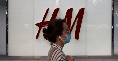 A woman walks past a store of the Swedish fashion retailer H&M at a shopping complex in Beijing, China, May 24, 2020. (Reuters Photo)