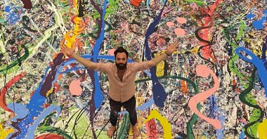 British artist Sacha Jafri stands on the giant canvas at The Atlantis hotel in Dubai, United Arab Emirates, Sept. 20, 2020. (Reuters Photo)