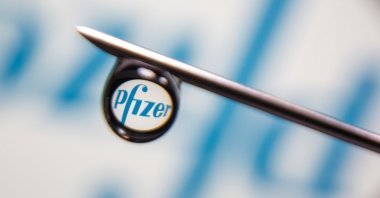 The Pfizer logo is reflected in a drop on a syringe needle in this illustration photo taken March 16, 2021. (REUTERS Photo)