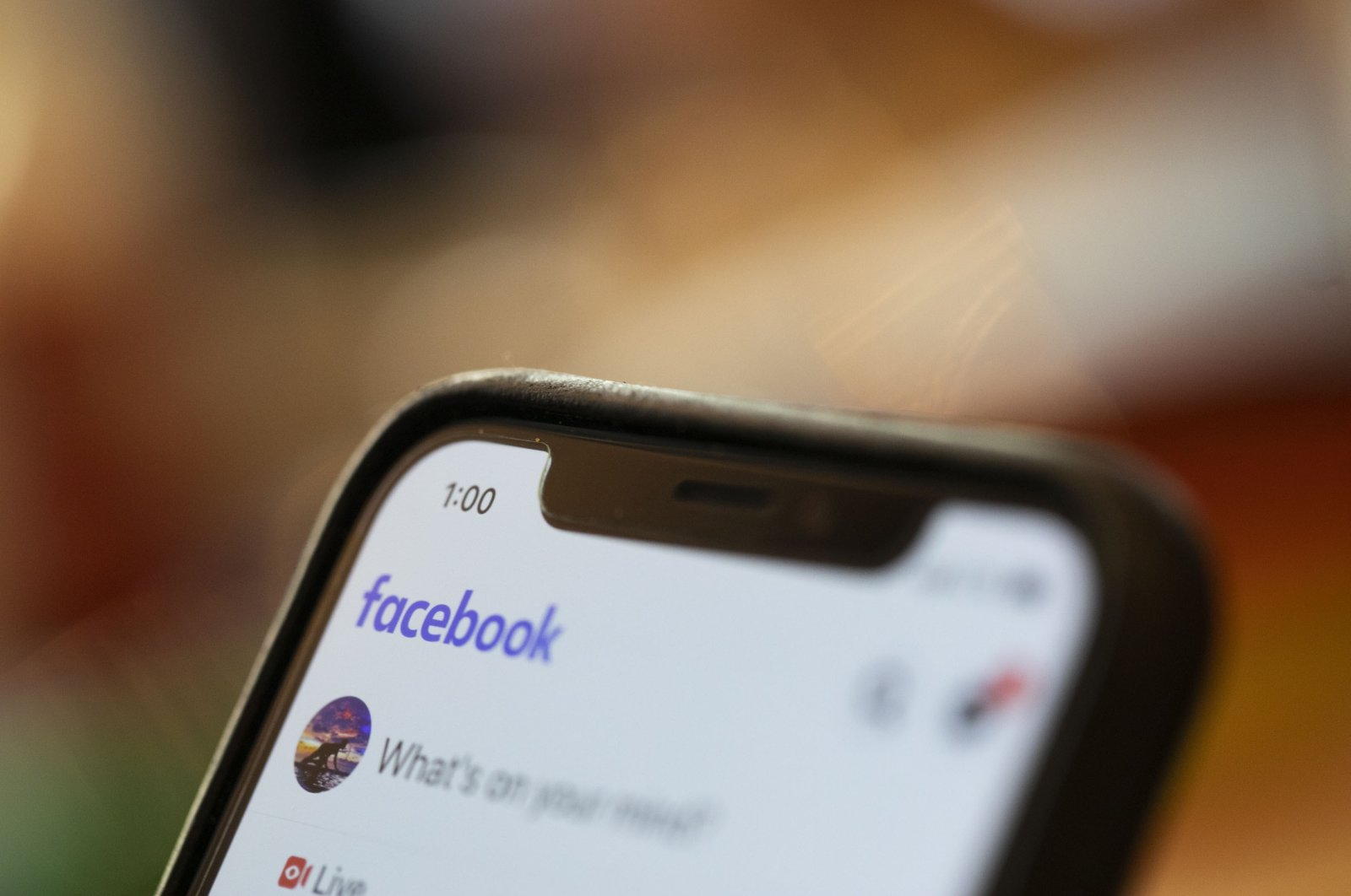 An iPhone displays a Facebook page in New Orleans, Aug. 11, 2019.  (AP File Photo)