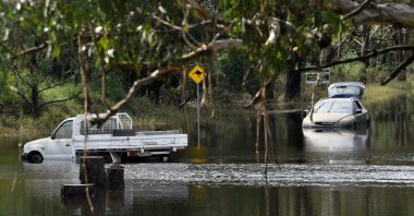 Cars sit in floodwaters as flood-stricken residents along Australia's east coast began a massive clean up effort following days of floods, Londonderry, Sydney, March 25, 2021. (AFP Photo)