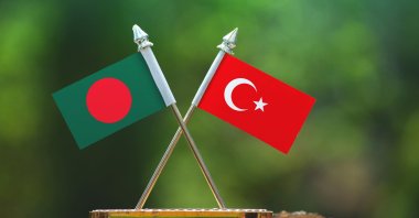 In this photo illustration, the flags of Bangladesh and Turkey are seen together with a blurred green background. (Photo by Shutterstock)