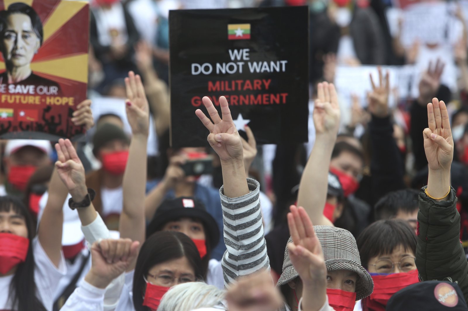 Myanmar nationals living in Taiwan make the three-finger salute of resistance as they attend a protest against the military regime in Myanmar at Liberty Square in Taipei, Taiwan, March 21, 2021. (AP Photo)