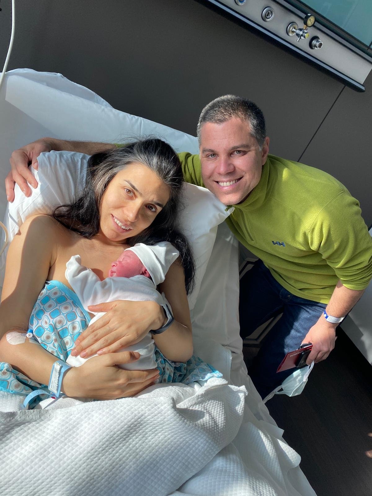 Mother Seda Giray (L) and her husband Deniz pose for a photo with their newborn baby Devin Ege inside a private hospital in Istanbul, Turkey, March 25, 2021. (DHA Photo)